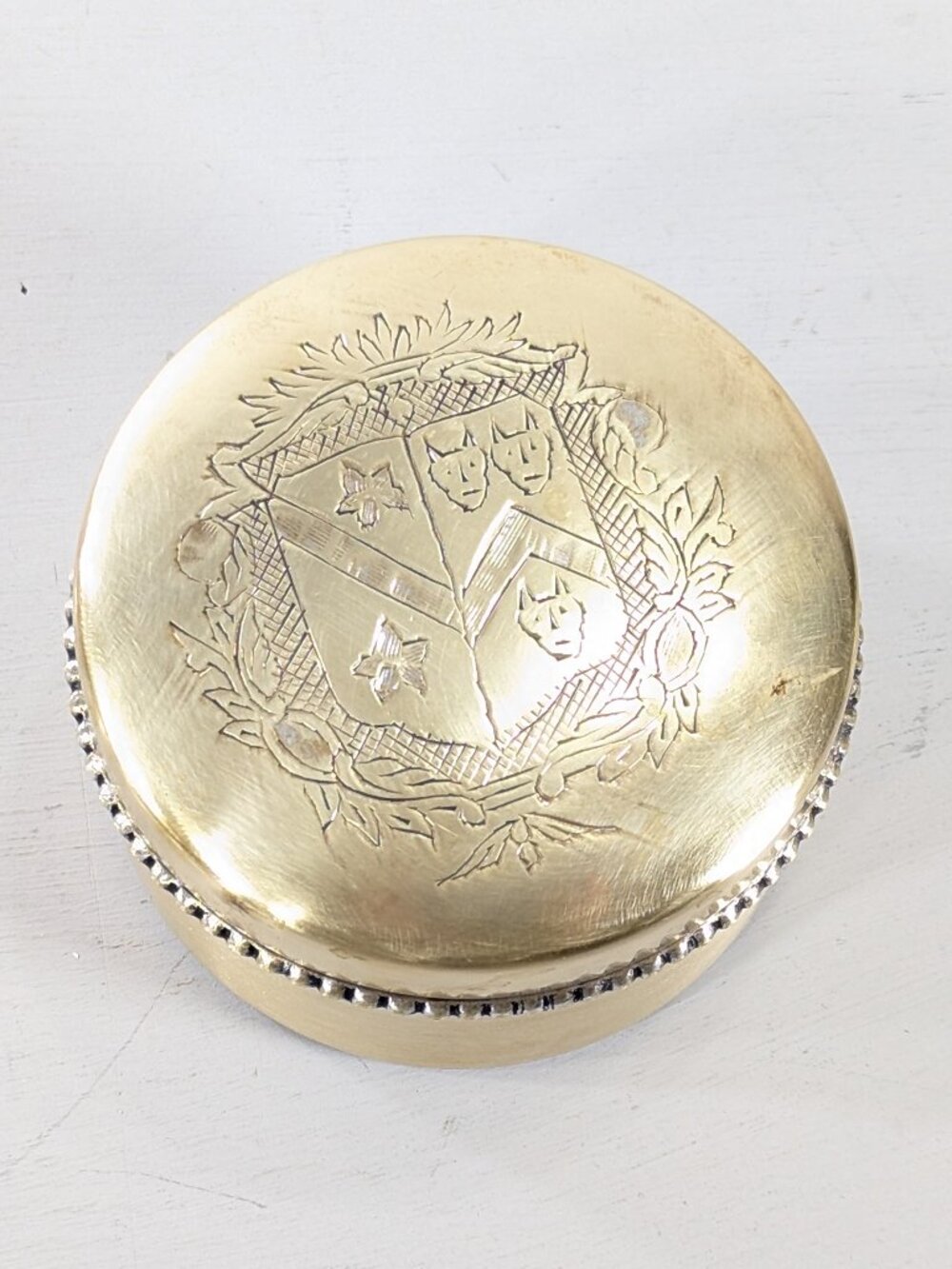 Silver plated trinket box with engraved devil head shield of arms, watch storage